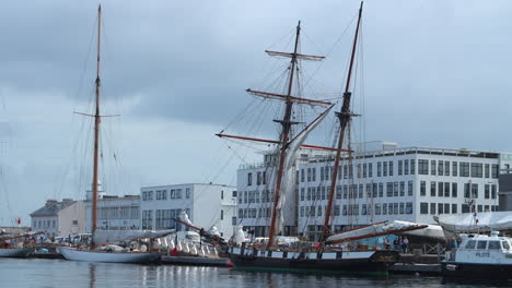 Sailboats-and-vintage-wooden-tall-ship-docked-in-Brest,-France-harbor