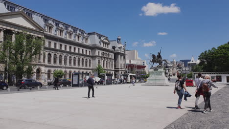 People-walking-through-University-Square,-Bucharest-Romania