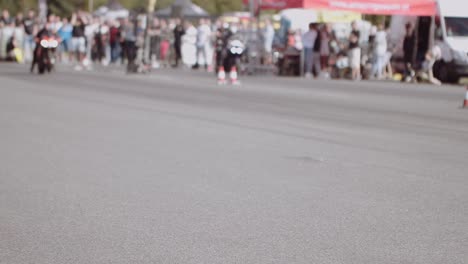 Abstract-shot-of-a-sports-bike-starting-a-race-n-the-track-with-crowded-backdrop