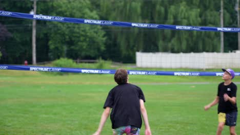 Young-teenage-boys-playing-volleyball-in-a-park-in-the-United-States