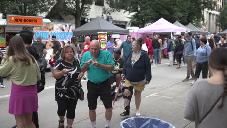 Taste-of-Madison-Woman-walking-towards-camera-eating