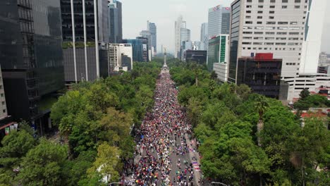 LGBTQ-Gay-Pride-Parade-party-in-sunny-Mexico-city---reverse,-aerial-overlook