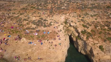 Visitors-enjoy-the-sun-at-Blue-Lagoon-from-the-cliffs-overlooking-the-sea-at-the-shoreline