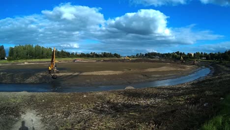 Excavators-are-working-with-Buckets-to-Clear-Mud-Sludge-and-Debris-from-the-Bottom-of-the-Drained-River