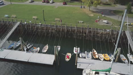 Flying-over-a-man-in-a-rowboat-in-Rockport-Harbor,-Maine