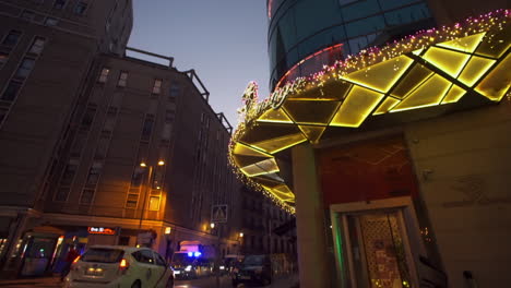 Tilt-up-view-to-colourful-mosaic-building-entrance---brightly-coloured-windows-on-the-corner-of-road-in-Madrid