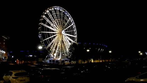 Dark-night-views-of-Echo-arena---lit-Ferris-wheel-in-motion-on-the-dock-waterfront