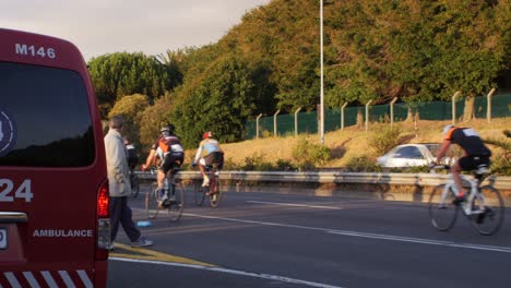 Cyclists-riding-away-with-ambulance-in-the-foreground