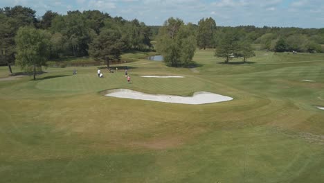 Aerial-view-of-golfers-on-a-putting-green