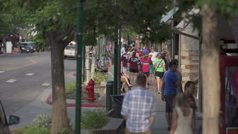 Static-shot-of-people-walking-around-small-downtown-tourist-town-in-the-mountains-of-Colorado