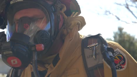 Firefighter-puts-on-an-oxygen-air-mask-so-he-can-breath-when-going-into-a-burning-building-with-smoke