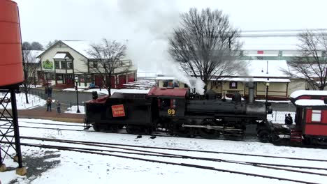 Aerial-conductor-on-a-restored-steam-powered-train-hand-signals-passengers-and-crew-it's-time-to-leave