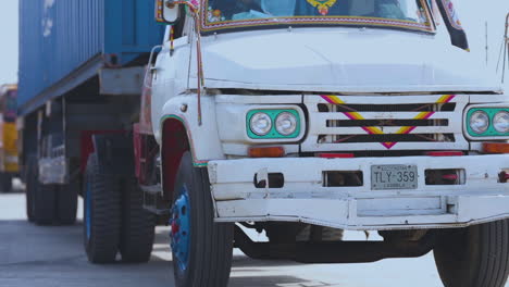 An-extreme-close-up-of-long-vehicle-trallers-entering-from-the-gate-of-a-port