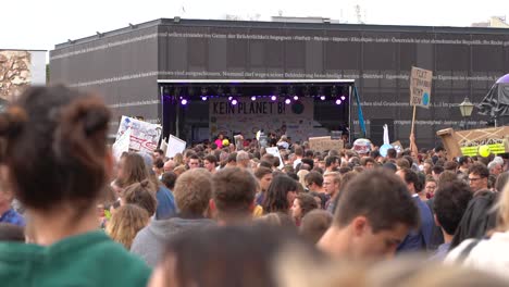 Masses-of-crowds-with-stage-in-distance-during-fridays-for-future-climate-change-protests-in-Vienna,-Austria