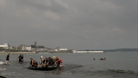 Local-business-team-winning-the-Newlyn-raft-race-charity-fun-outdoors-event,-Cornwall