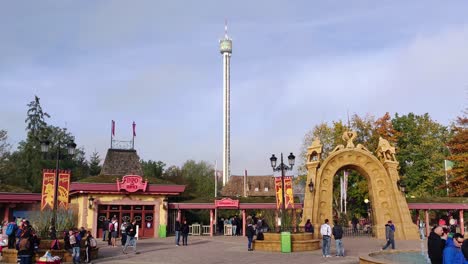 Gente-Divirtiéndose-En-El-Parque-De-Vacaciones-Hassloch,-Alemania,-Mientras-Una-Torre-De-Caída-Libre-De-Anubis-Está-Montando