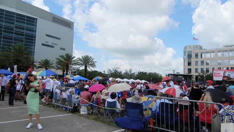 People-gather-to-hear-ans-see-President-Donald-Trump-at-a-political-rally