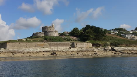 Moving-in-a-Boat-Past-St-Mawes-Castle,-Cornwall-on-a-Hot-Summers-Day,-handheld-shot