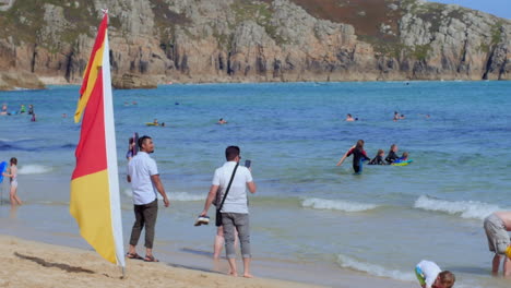 People-young-and-old-together-having-summer-holiday-fun-at-the-beach-,slow-motion