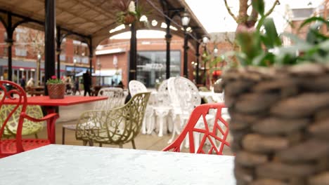 Empty-city-coffee-shop-outdoor-colourful-tables---chairs-reveal-dolly-left