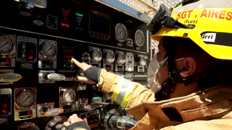 Firefighter-checks-the-firetruck-equipment-panel-while-responding-to-a-fire-at-a-COVID-19-treatment-hospital