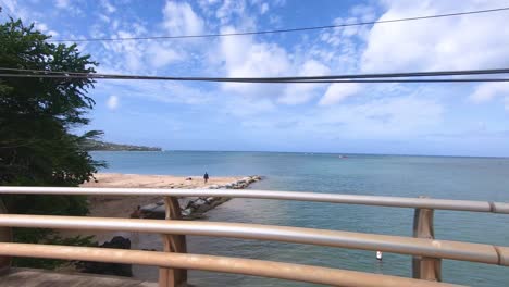 Driving-over-small-bridge-at-Kai-region-of-island-Oahu-on-Hawaiian-islands