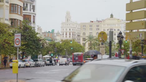 A-panoramic-view-of-a-landmark-street-Town-Hall-Square-with-amazing-architecture,-buildings-and-public-movement-at-Valencia,-Spain