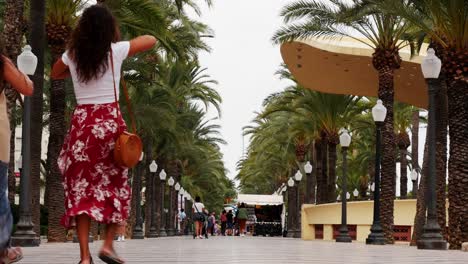 Locked-shot-of-People-walking-with-protective-masks-in-Alicante,-Spain