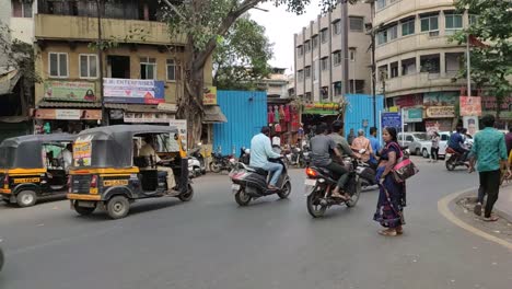 A-woman-tries-to-cross-a-busy-street-near-Shaniwar-Wada-in-Pune-India