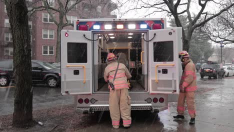 Paramedics-assisting-injured-citizen-in-stretcher,-placing-him-in-ambulance-on-ConEd-power-cable-incident-day---Wide-static-shot