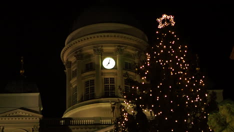 Christmas-tree-with-the-dome-of-the-Helsinki-cathedral-on-the-background-at-night