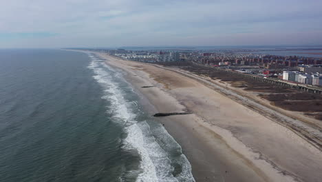 A-high-angle-view-of-an-empty-beach-on-a-beautiful-day-with-a-few-clouds