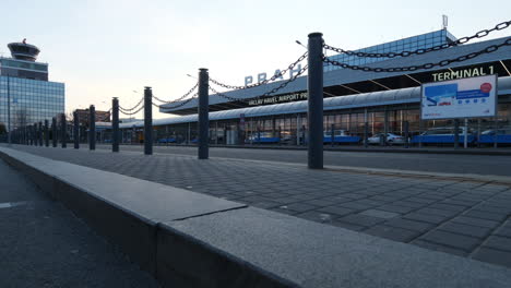 Vaclav-Havel-Prague-Airport,-Idle-Main-Terminal-Building-During-Covid-19-Virus-Outbreak,-Lockdown-and-Travel-Ban,-Cinematic-Low-Angle-View-From-Parking-Lot,-Czech-Republic