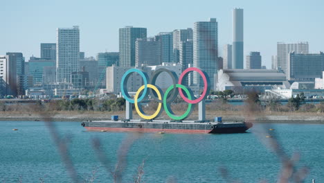 Una-Toma-Fija-Del-Monumento-De-Los-Anillos-Olímpicos-Frente-A-Las-Costas-Del-Parque-Marino-De-Odaiba-En-Tokio,-Japón