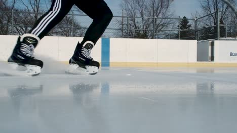 Eisläufer,-Der-In-Zeitlupe-Auf-Einer-Eisbahn-Anhält-Und-Wieder-Losfährt