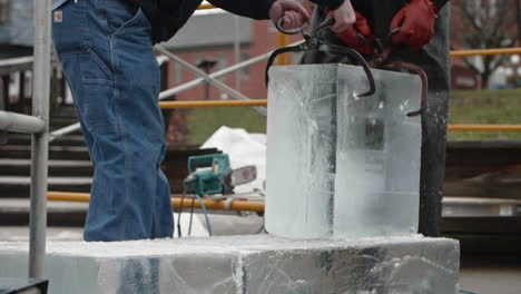 Escultor-De-Hielo-Y-Asistente-Moviendo-Un-Gran-Bloque-De-Hielo,-Cámara-Lenta