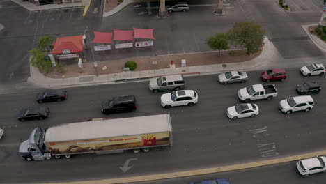 Large-truck-turning-left-at-a-busy-intersection-opposite-a-gas-petrol-station