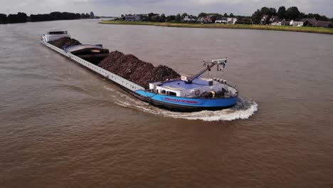 Aerial-Across-Bow-Of-Finn-Lucas-Deymann-Cargo-Ship-Along-River-Noord