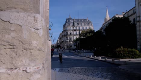 tracking-shot-leading-to-a-city-street-with-cyclists-coming-on-the-camera