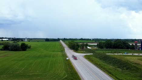 Aerial-view-of-trucks-leaving-an-active-quarry-pit