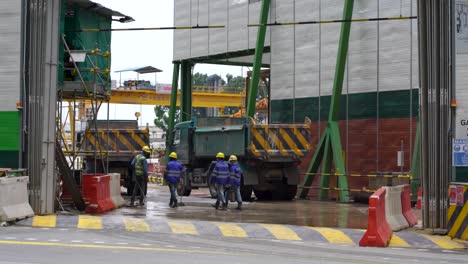 Trucks-and-workers--at-construction-site-downtown-Singapore