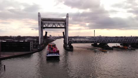 Aerial-View-Of-Sensation-Cargo-Ship-Slowly-Passing-Through-Raised-Spoorbrug-Railway-Bridge