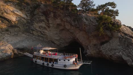 Aerial-view-of-young-diver-standing-on-a-luxury-boat-in-resort-village-on-the-southwest-coast-of-Turkey