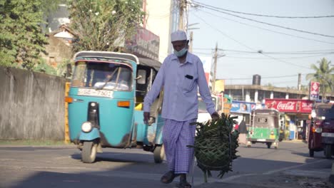 Man-carries-basket-down-busy-Sri-Lankan-street