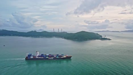 4K-Cargo-Ship-sailing-on-the-sea-near-Lamma-Island-in-Hong-Kong-in-the-evening