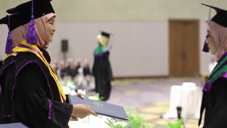 Professor-handshake-of-graduate-congratulations-celebrating-with-giving-diplomas-certificate-in-hand-and-feeling-so-happiness-in-Commencement-day