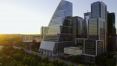 Aerial-view-of-the-Google-building,-at-the-Colorado-river-in-Austin,-sunset-in-USA---pan,-drone-shot