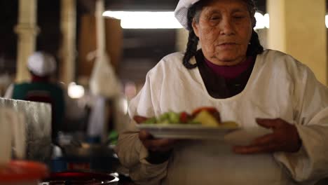 a-traditional-paruvian-lady-serving-food