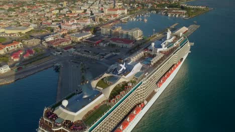 Aerial-topdown-overview-of-people-on-the-upper-deck-on-a-big-cruise-ship-with-smoke-in-the-ship-funnels-4K