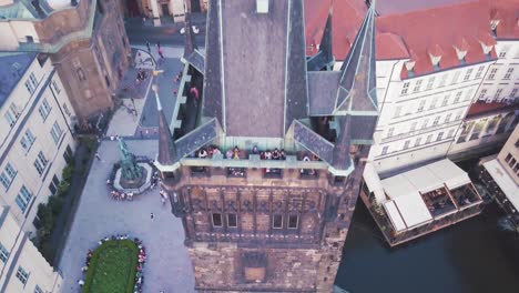 Aerial-tilts-over-tall-structure-with-tourists-on-viewing-platform